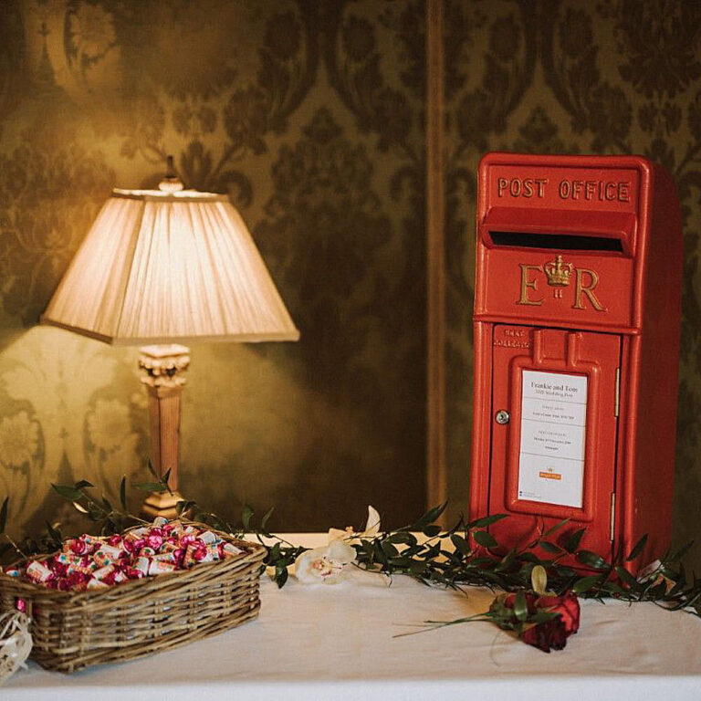 Red Royal Mail wedding post box set up at a wedding reception for guests' cards